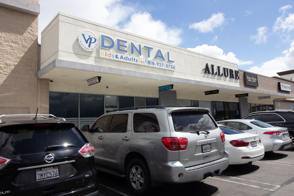 Victory plaza dental group building outside view and parking area with cars