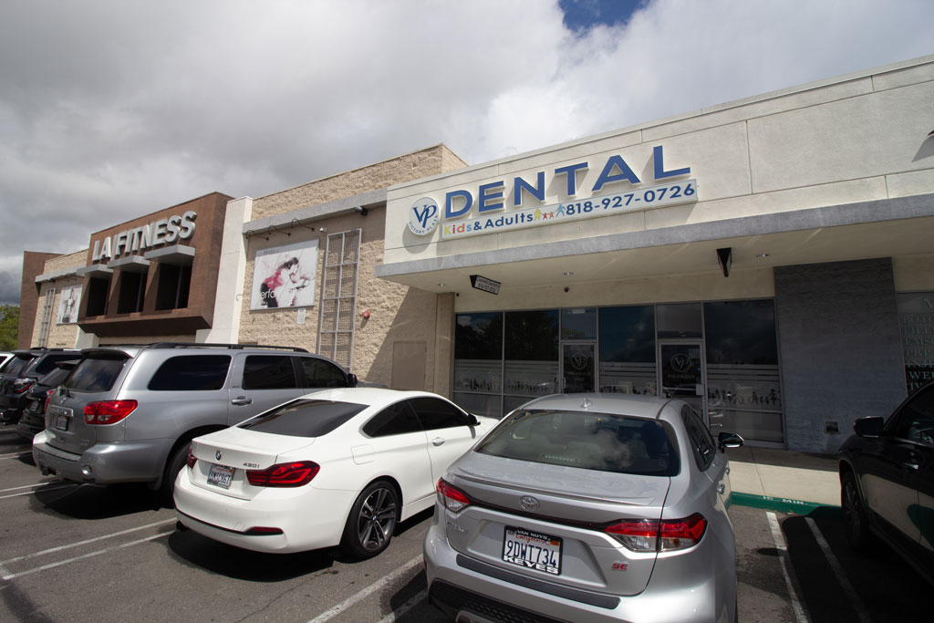 Victory plaza dental group building outside view and parking area with cars